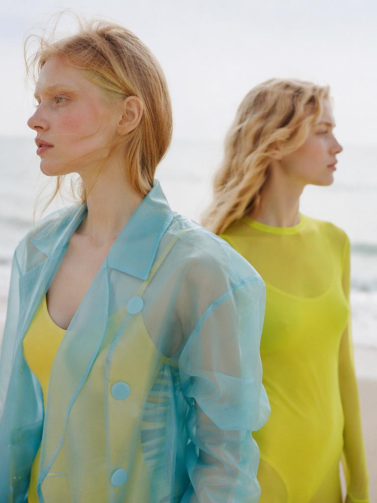 The color-blocked transparency: a cyan translucent organza jacket layered over a bold yel...