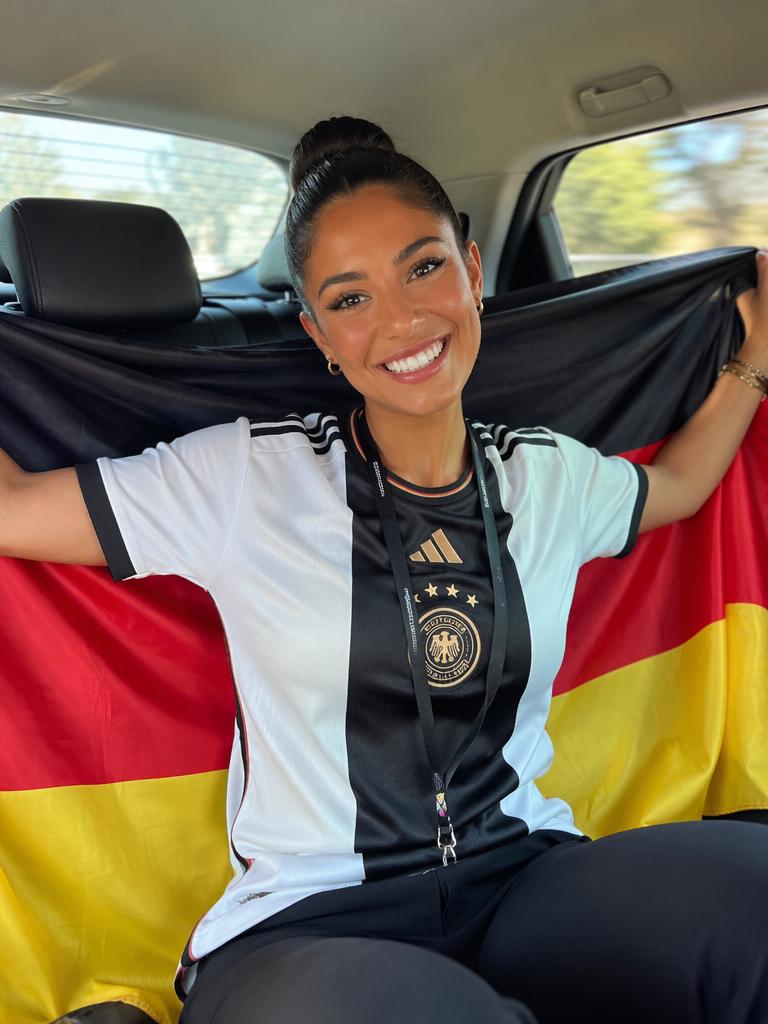 The bright, genuine smile and the contrast between the sharp black-and-white Germany jers...