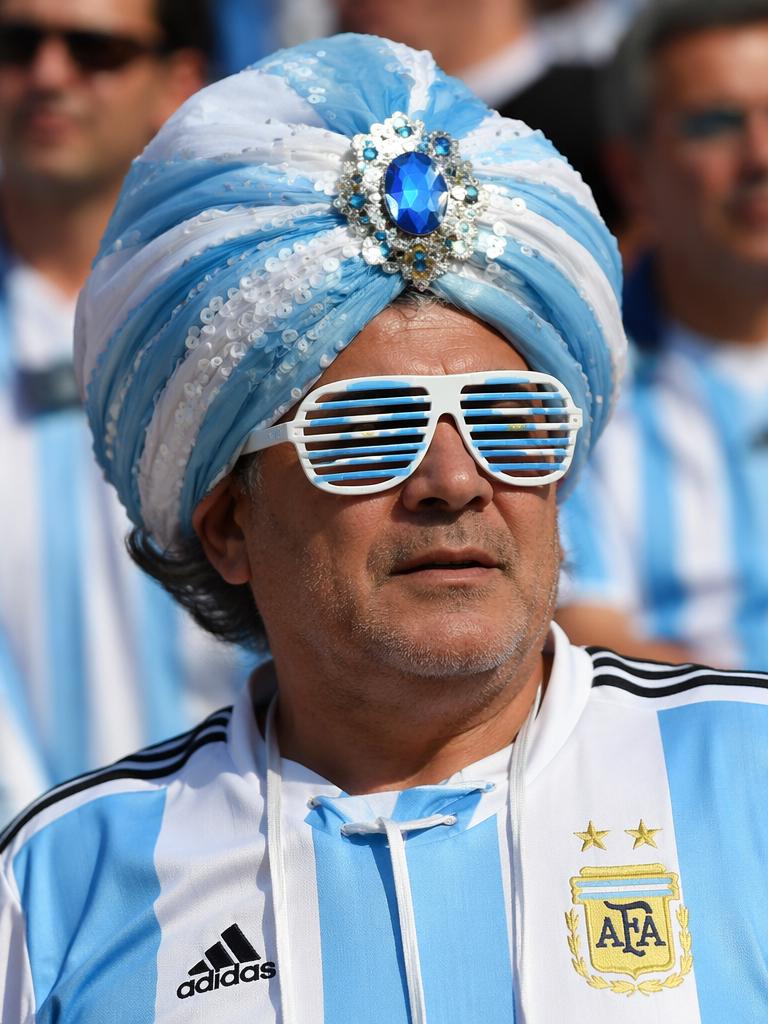 A Man Wearing A Decorative Blue-And-White Turban And An Argentina Football Jersey Stands In A Crowd Of Fans